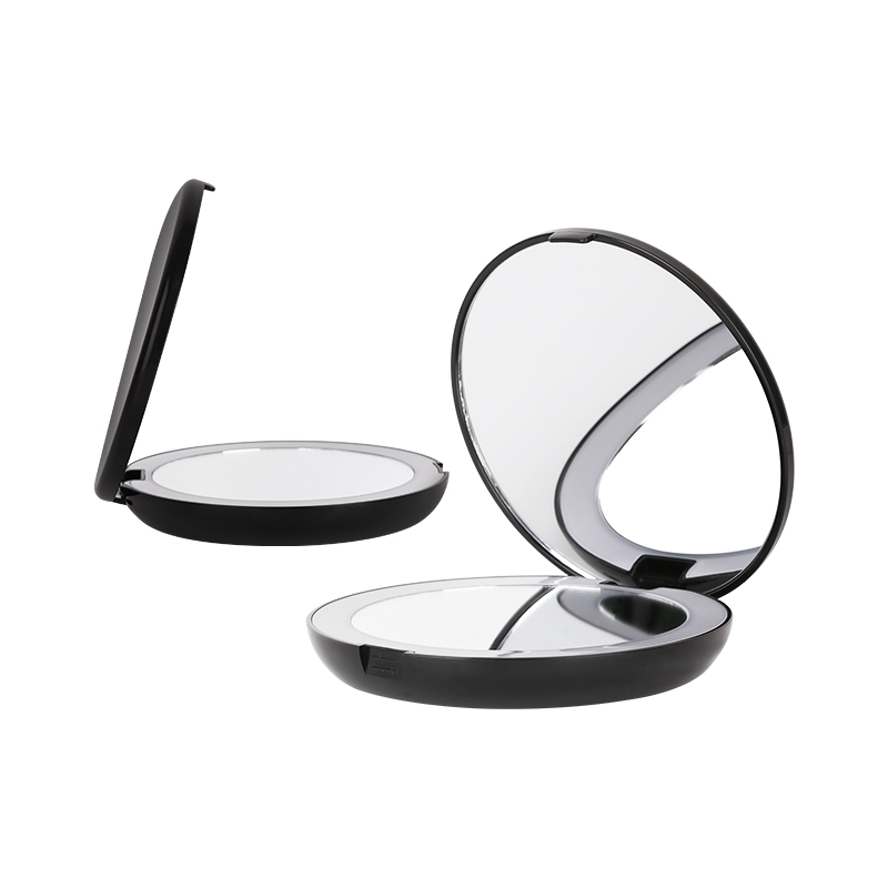 Double-sided black compact handheld mirror opened to show travel-ready format