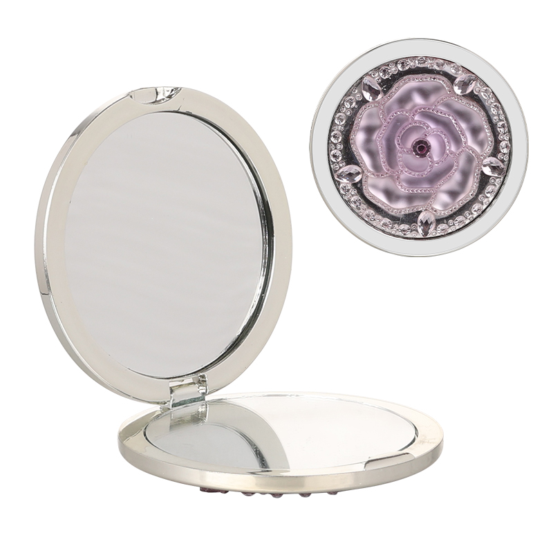 Decorative compact mirror shown open for retail beauty accessory assortment planning