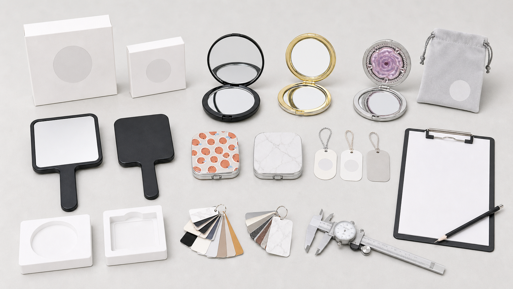Handheld mirror product line sample approval table with complete mirrors, boxes, pouches, swatches, and inspection tools